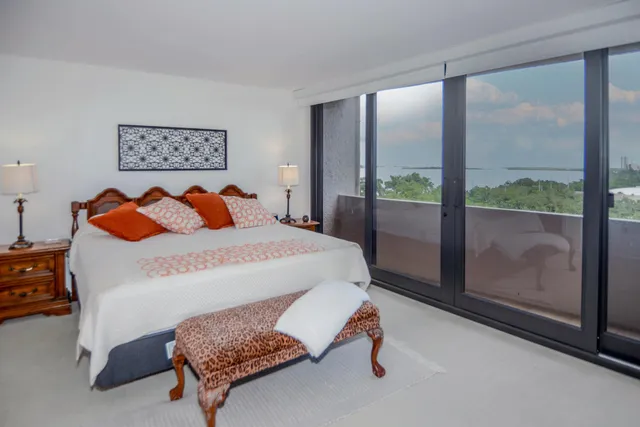 a bedroom with a bed and a large window