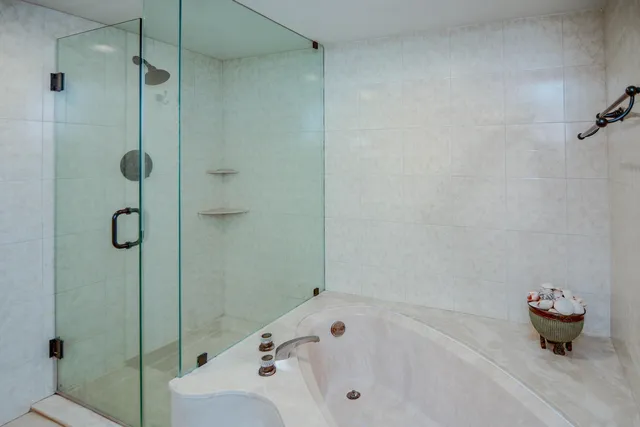 a bathroom with a tub and a shower