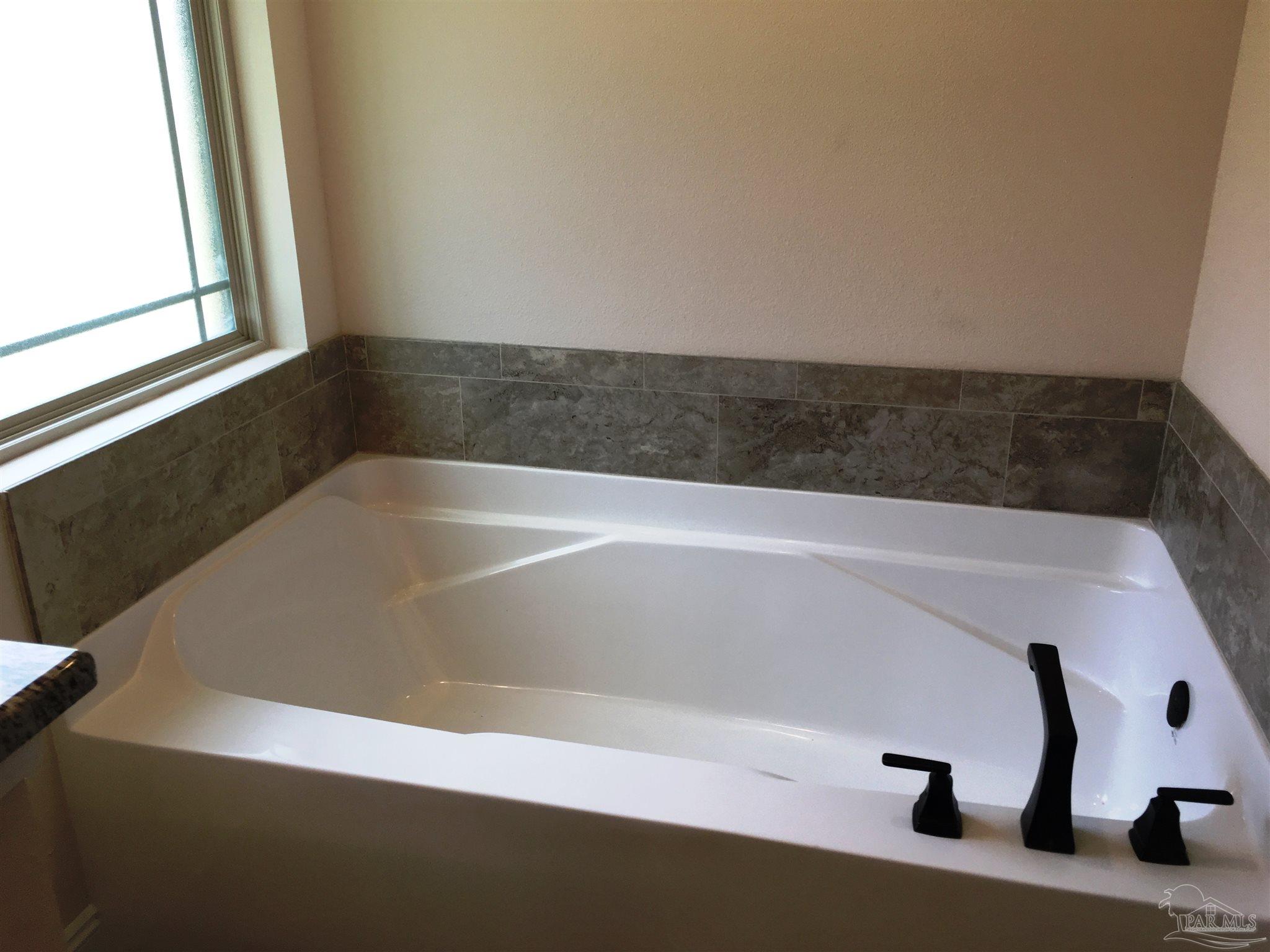5308 South A Jones Road Milton, FL 32583 - Photo 16 of 27 Master bath has a tub & separate fiberglass shower