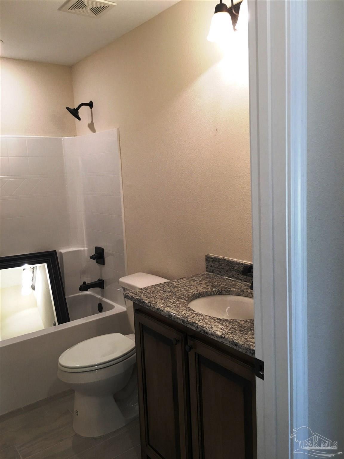 5308 South A Jones Road Milton, FL 32583 - Photo 23 of 27 A 3rd bath also has a shower/tub combination.