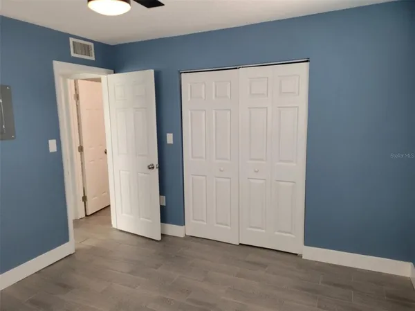 a view of an empty room with closet area