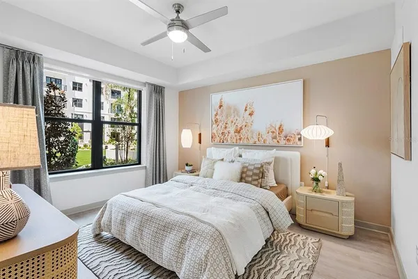 a bedroom with a large bed and a window