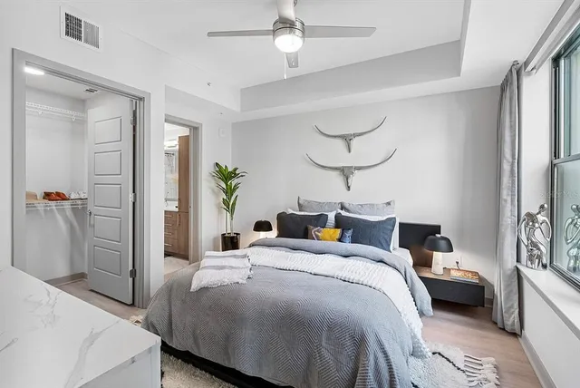 a bedroom with a bed and a chandelier