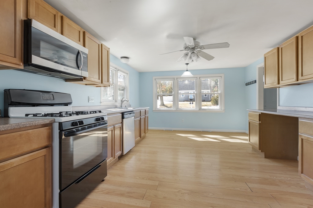 21 River Road Marion, MA 02738 - Photo 4 of 29 a kitchen with stainless steel appliances granite countertop a stove a microwave and a refrigerator