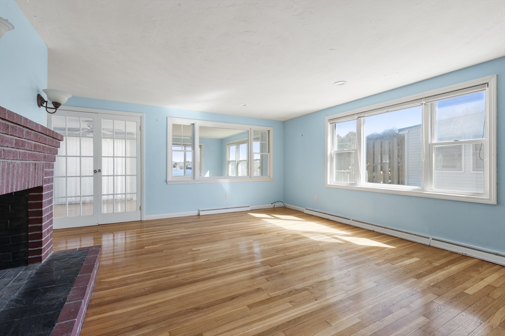 21 River Road Marion, MA 02738 - Photo 7 of 29 a view of an empty room with wooden floor and a window