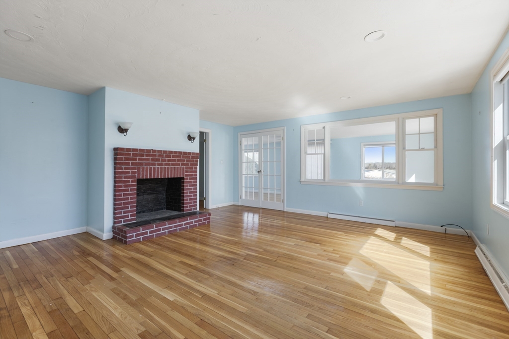 21 River Road Marion, MA 02738 - Photo 8 of 29 a view of empty room with wooden floor and fireplace