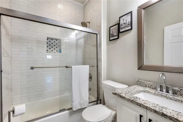 a bathroom with a glass shower door