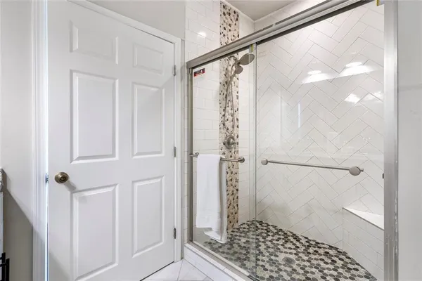 a bathroom with a glass shower door