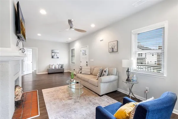 a living room with furniture a fireplace and a flat screen tv