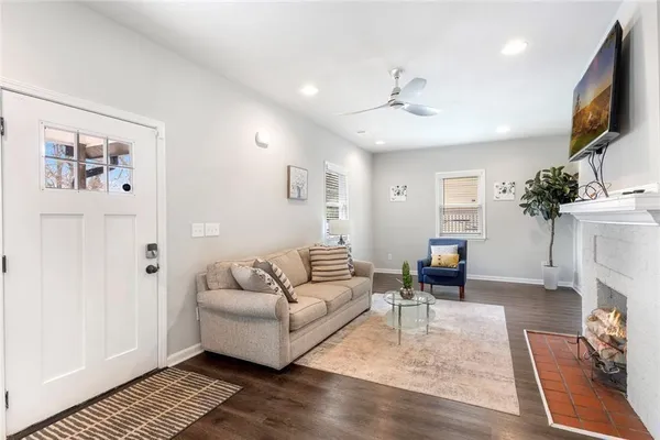 a living room with furniture a fireplace and a window