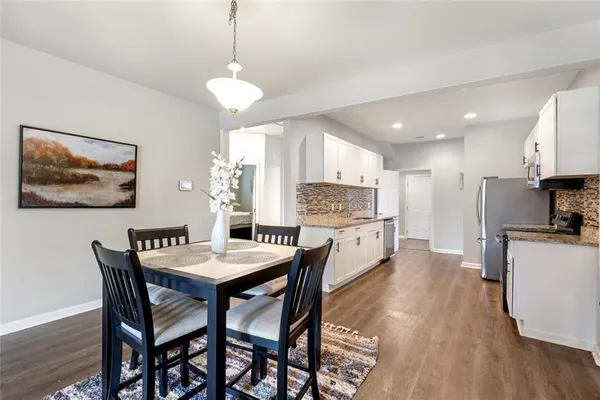 a large kitchen with a table and chairs