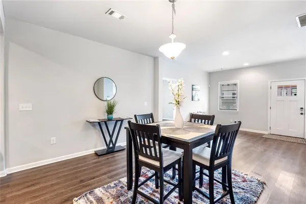 a view of a dining room with furniture and wooden floor