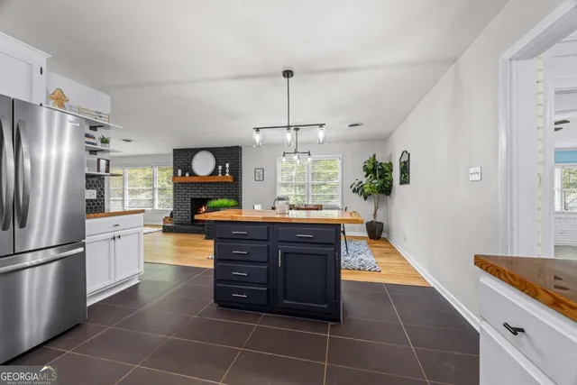 a kitchen with stainless steel appliances granite countertop a refrigerator a stove and a sink