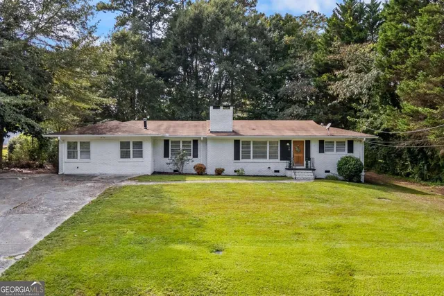 a front view of a house with swimming pool having outdoor seating