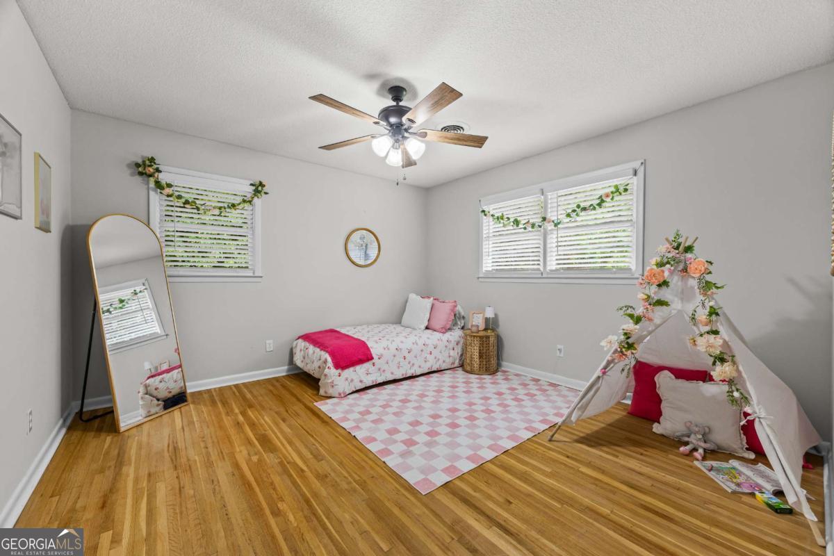 110 Valley Road Toccoa, GA 30577 - Photo 30 of 39 a bedroom with a bed and wooden floor