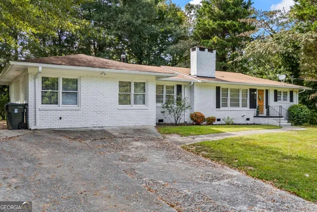 a front view of house with yard and green space