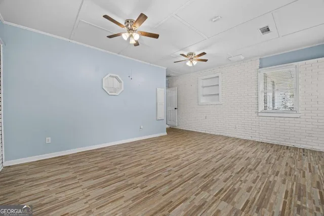 wooden floor in an empty room with a window