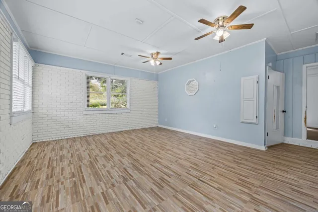 wooden floor in an empty room with a window