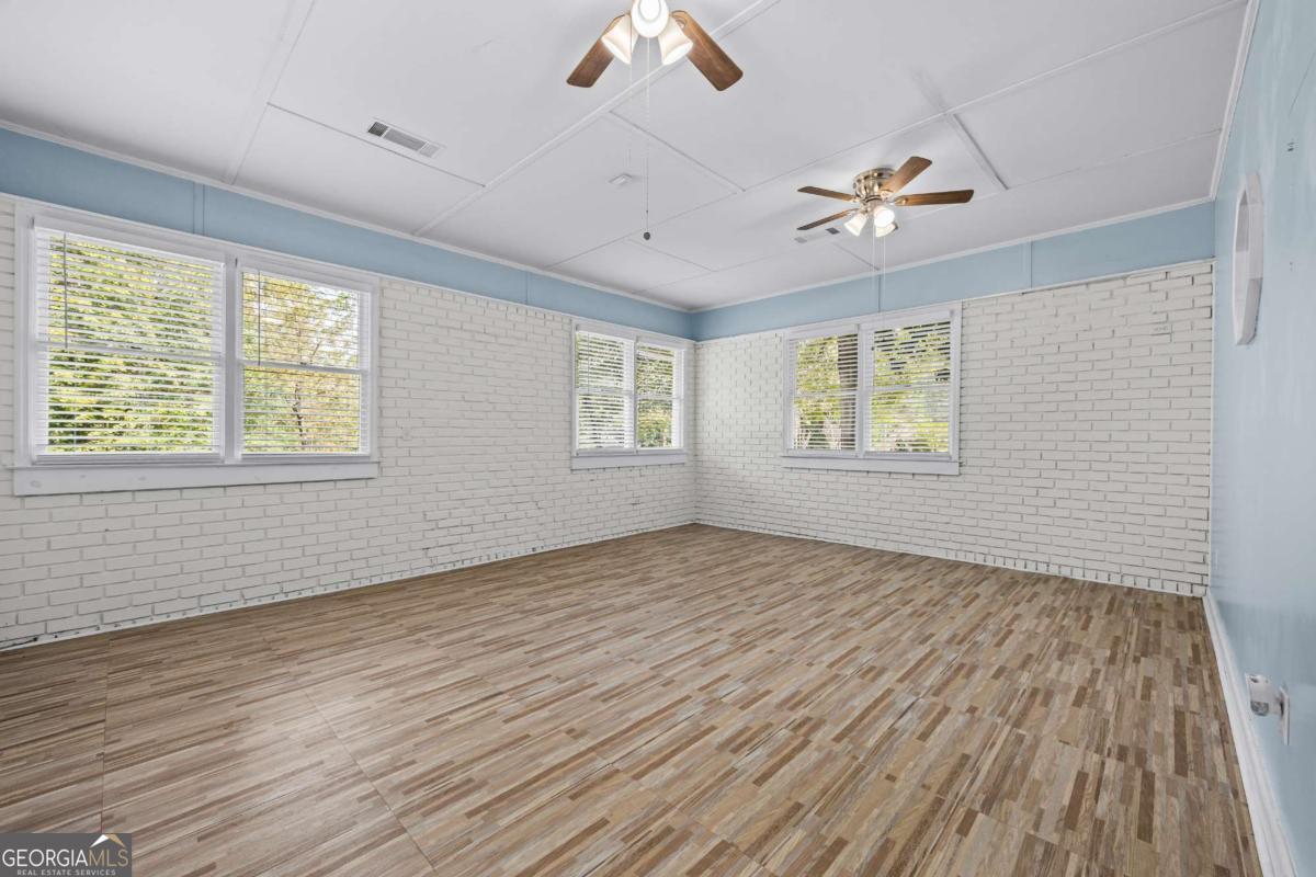 110 Valley Road Toccoa, GA 30577 - Photo 36 of 39 a view of an empty room with wooden floor and a window