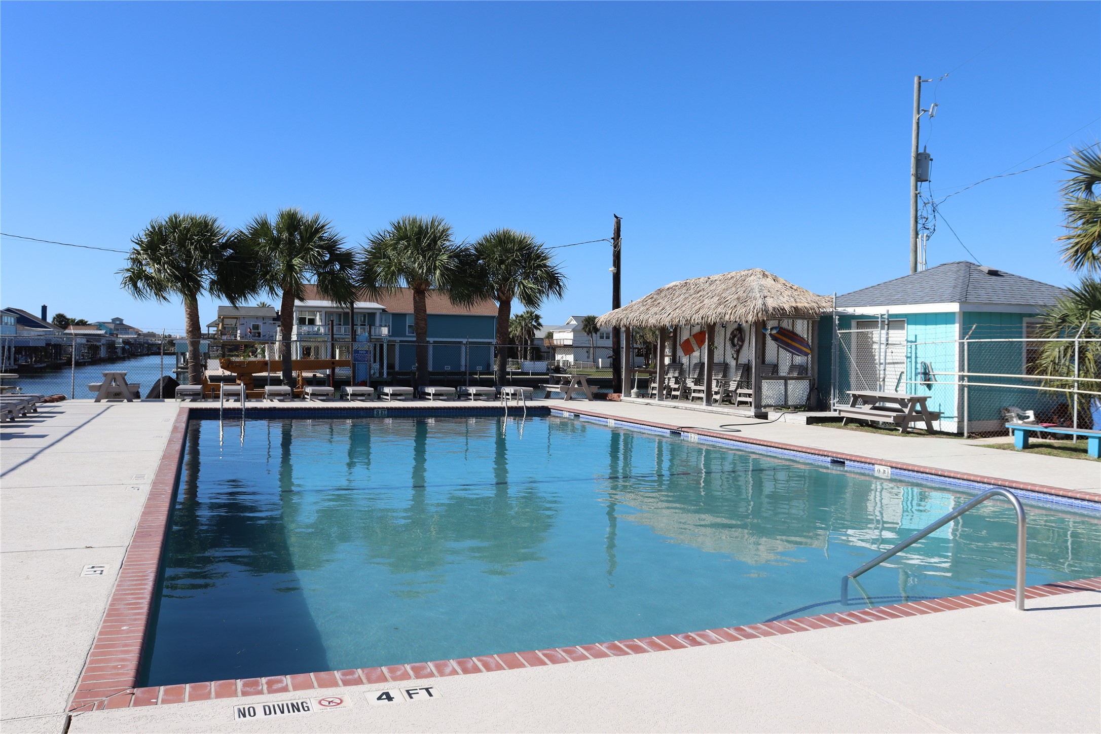 4123 Reeves Drive Galveston, TX 77554 - Photo 16 of 28 a swimming pool with outdoor seating and yard