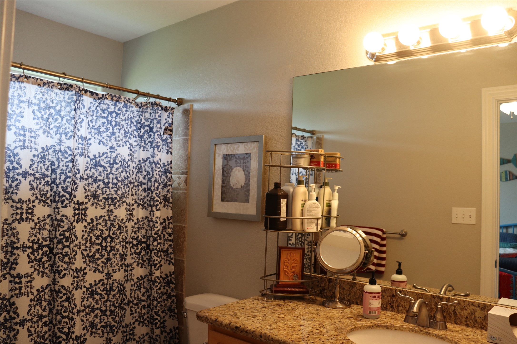 4123 Reeves Drive Galveston, TX 77554 - Photo 5 of 28 a bathroom with a sink and a mirror