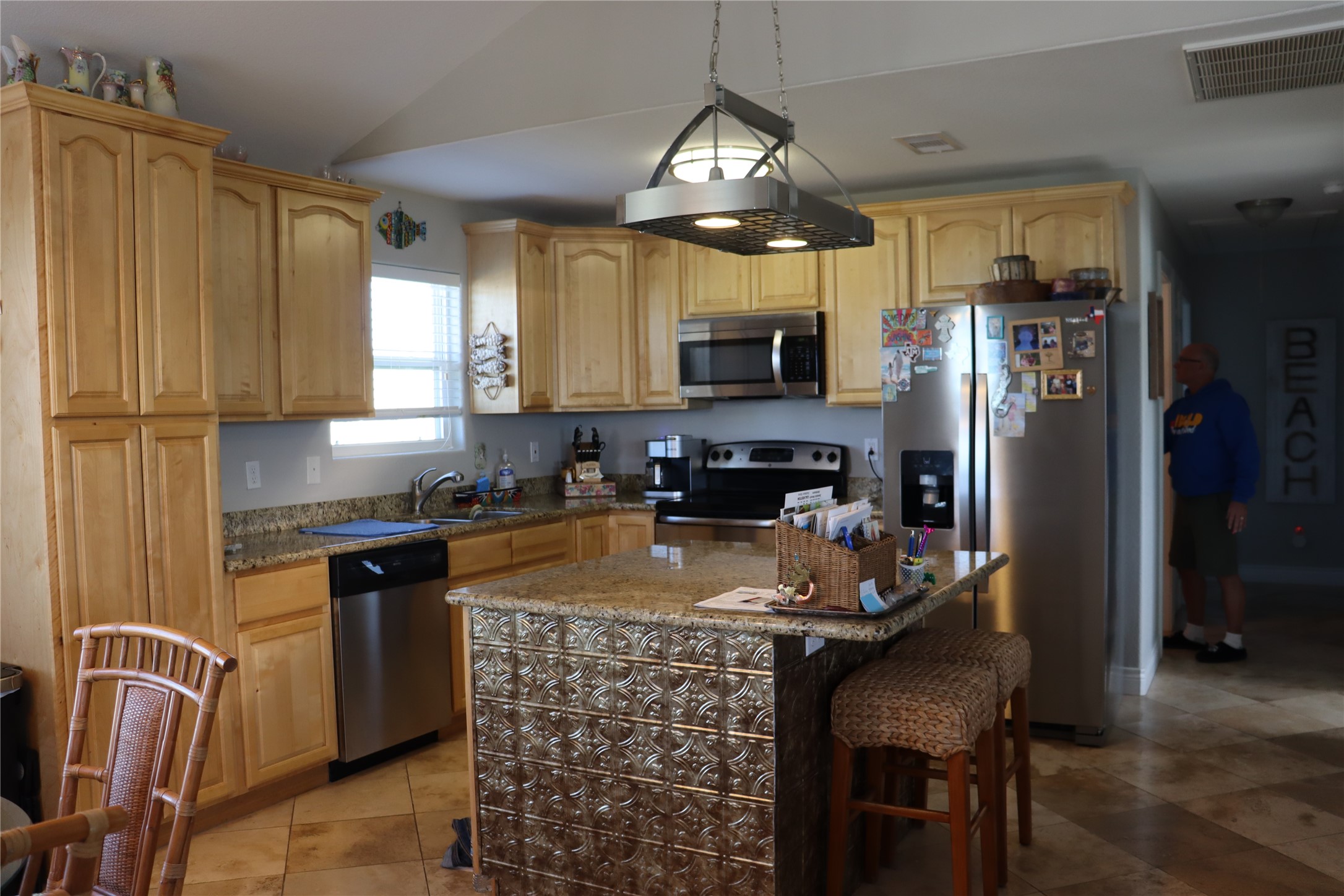 4123 Reeves Drive Galveston, TX 77554 - Photo 7 of 28 a kitchen with stainless steel appliances granite countertop a stove refrigerator sink and cabinets