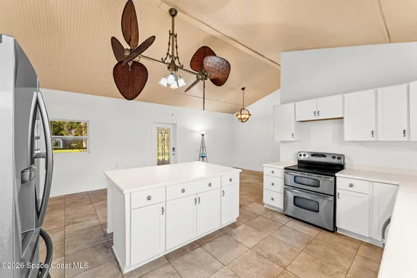 a kitchen with a stove cabinets and a refrigerator