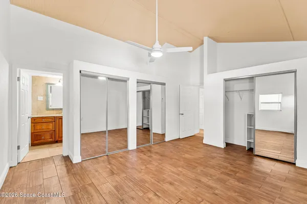 a bathroom with a granite countertop sink mirror vanity bathtub and a toilet