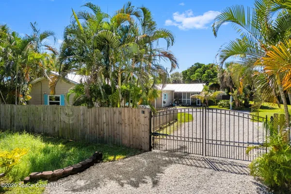 an aerial view of a house with a yard and swimming pool