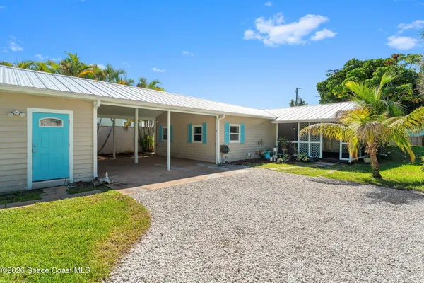 a view of a house with a yard patio and swimming pool
