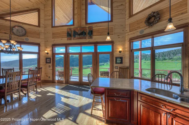 a bedroom with furniture and large windows