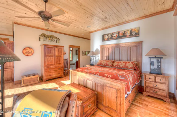 a bed sitting in a spacious bedroom next to a window