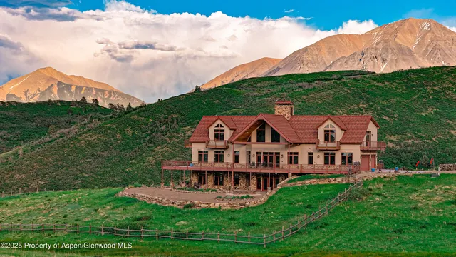 a view of a balcony with chairs and wooden floor