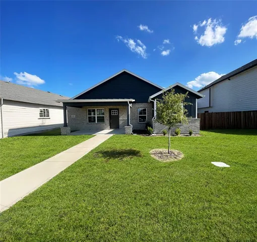 a big house with a big yard and potted plants