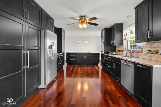 a view of a kitchen with cabinets and stainless steel appliances