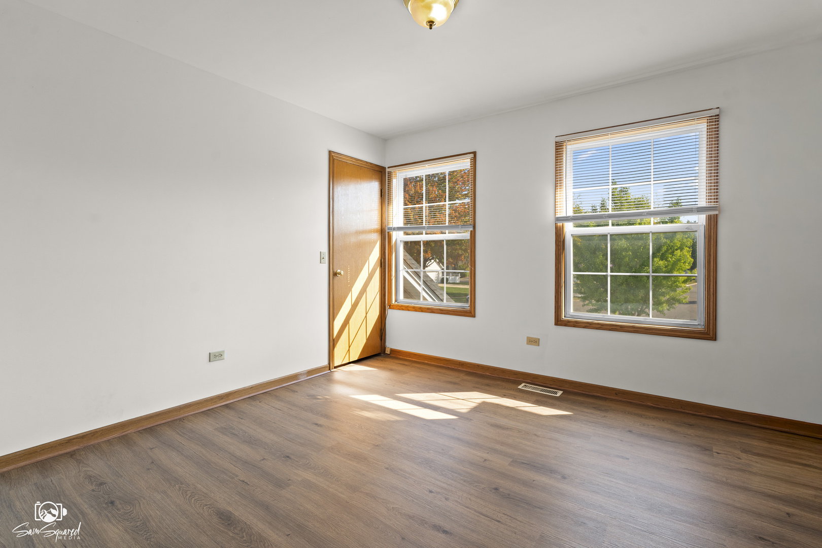 3209 Sunset Court Crest Hill, IL 60403 - Photo 34 of 38 a view of an empty room with wooden floor and windows