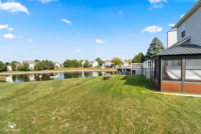 a view of a house with a yard and sitting area