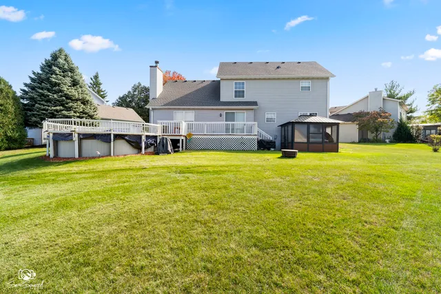 a view of a house with a big yard and large trees
