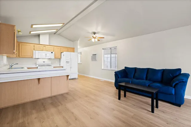 a living room with furniture and a kitchen island