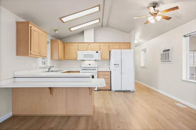 a kitchen with stainless steel appliances a stove a sink and a refrigerator