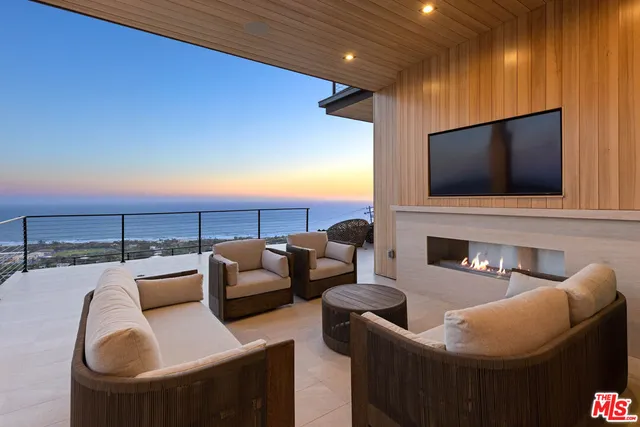 a outdoor living space with furniture and a flat screen tv