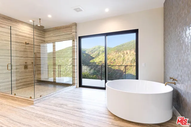 a bathroom with a bathtub and shower