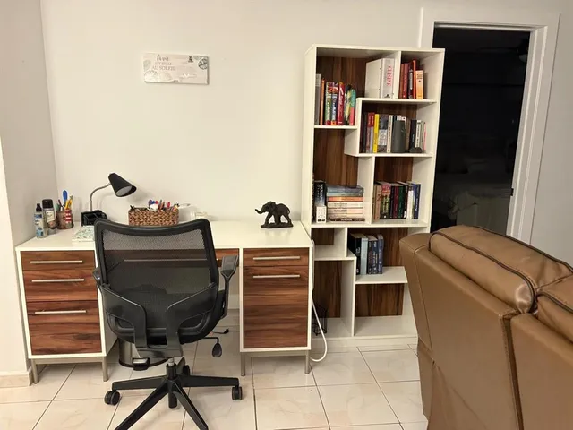 a view of a workspace with furniture