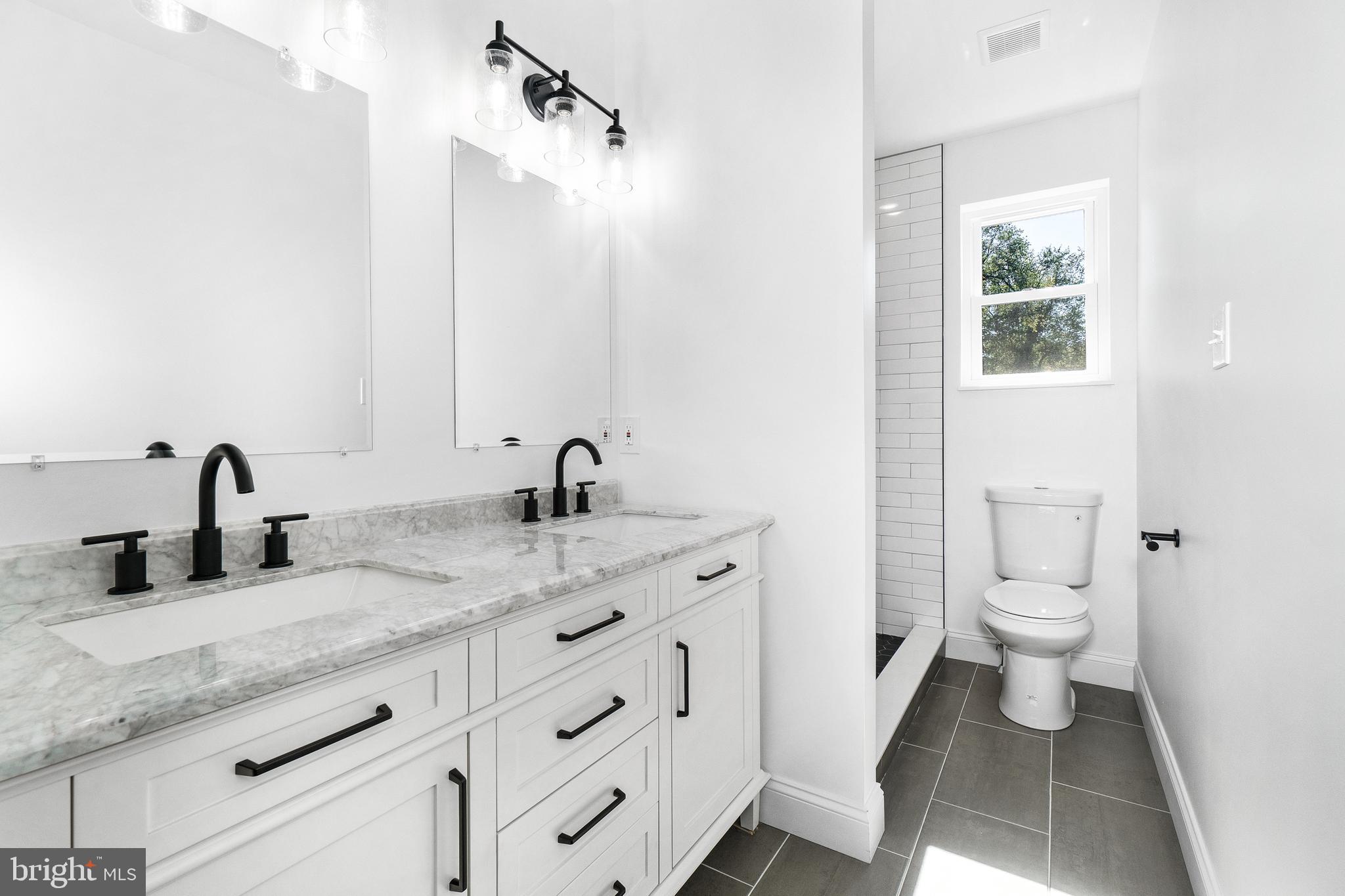 40 Brookside Road Glenside, PA 19038 - Photo 16 of 35 a bathroom with a granite countertop sink a toilet and a mirror