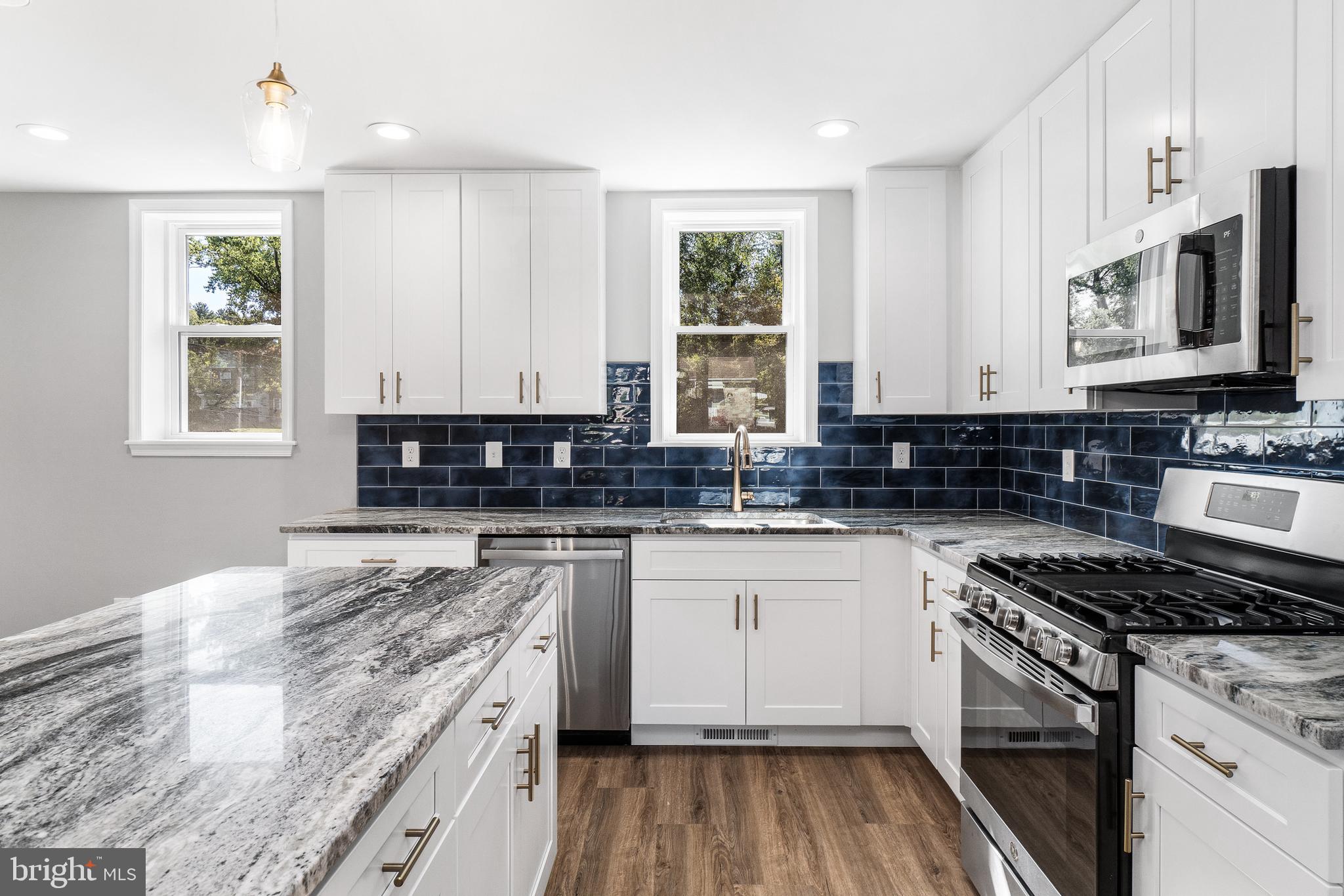 40 Brookside Road Glenside, PA 19038 - Photo 2 of 35 a kitchen with stainless steel appliances granite countertop a stove a sink and a microwave