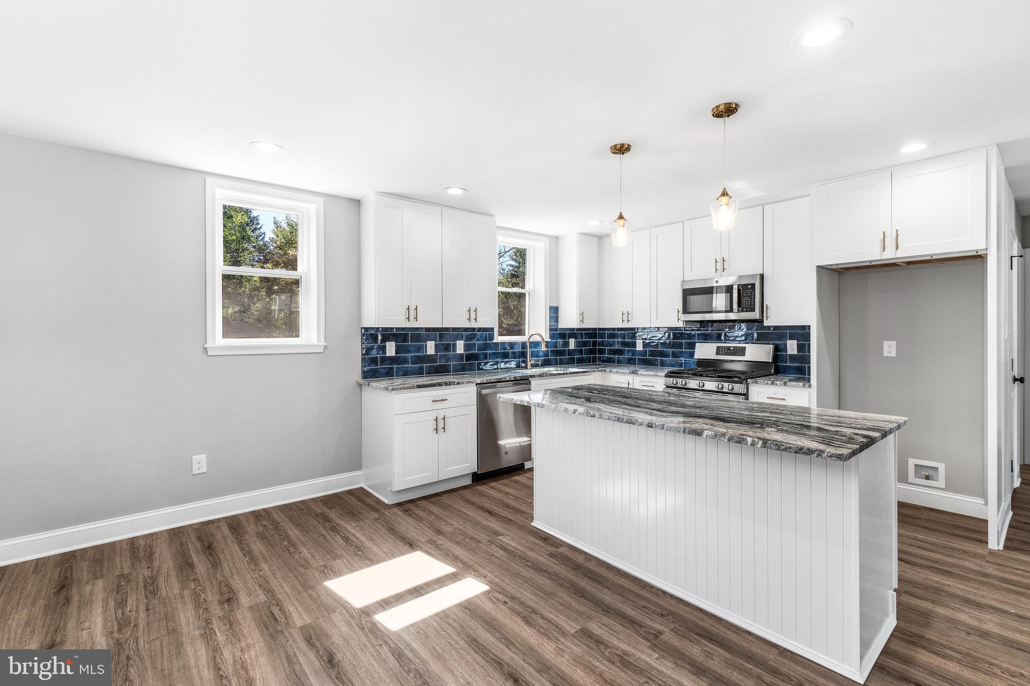 40 Brookside Road Glenside, PA 19038 - Photo 28 of 35 a kitchen with stainless steel appliances granite countertop a stove a sink and a refrigerator