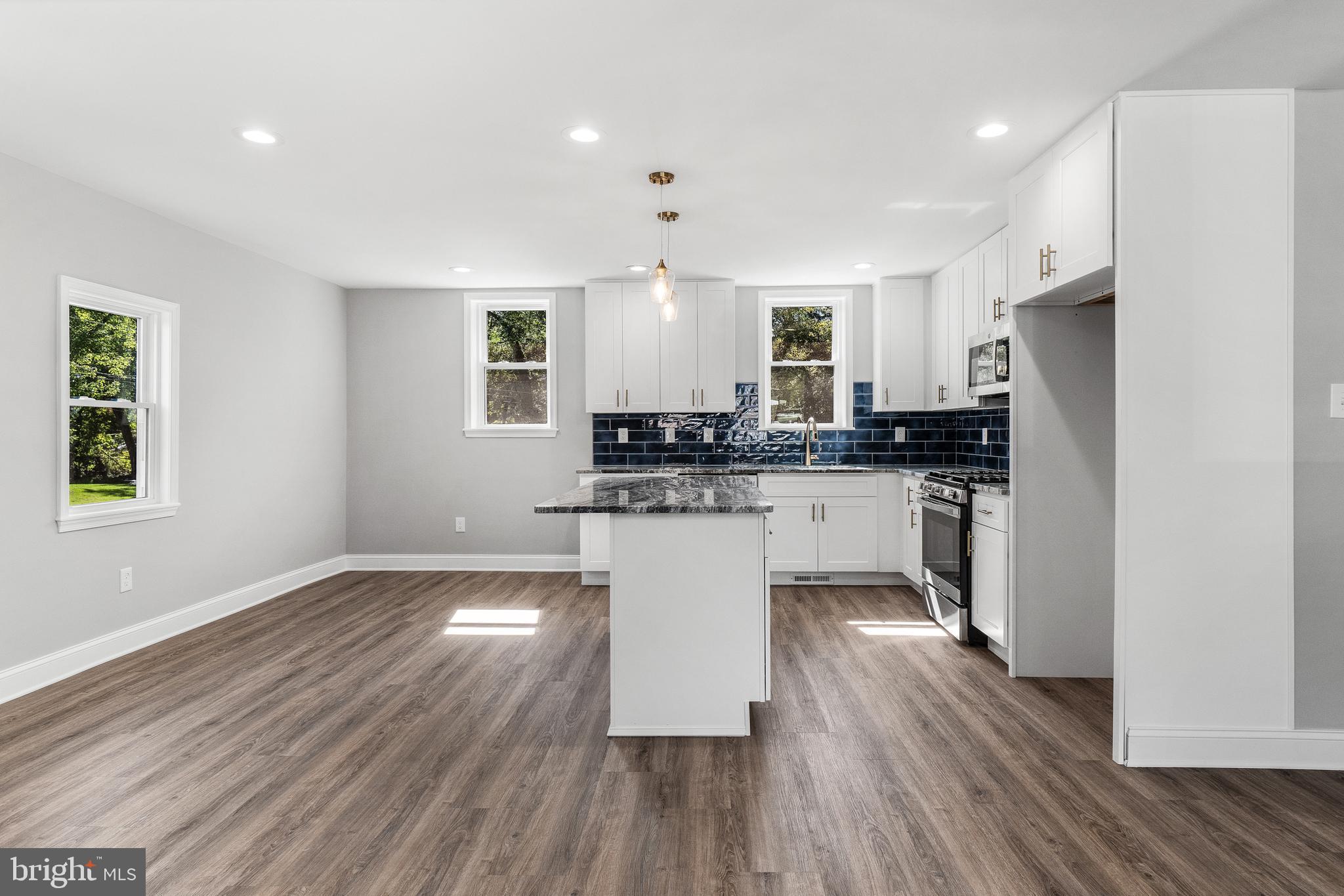 40 Brookside Road Glenside, PA 19038 - Photo 5 of 35 a kitchen with a refrigerator and white cabinets