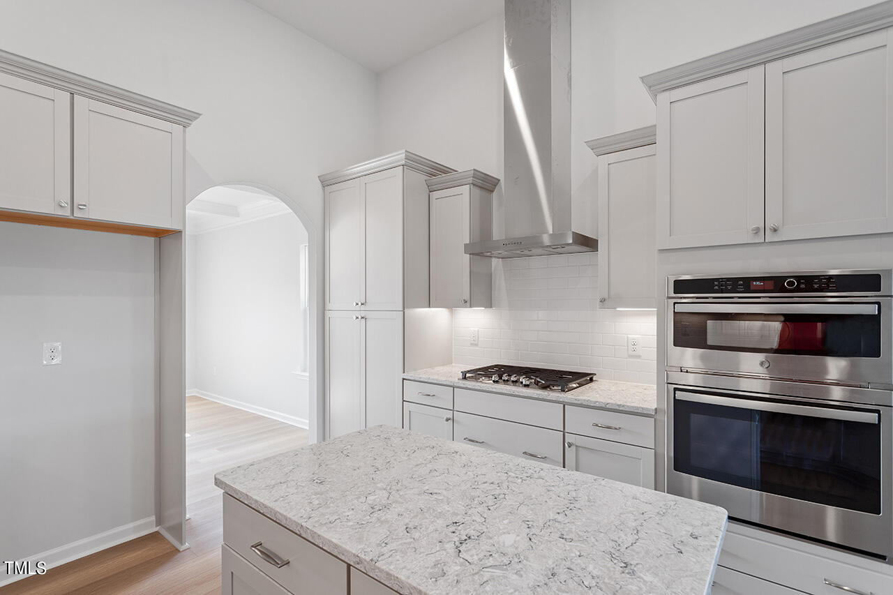 63 Beech Tree Way, Unit 139 Garner, NC 27529 - Photo 12 of 25 a kitchen with granite countertop a stove and a refrigerator