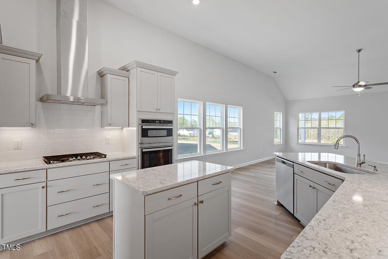63 Beech Tree Way, Unit 139 Garner, NC 27529 - Photo 13 of 25 a kitchen with cabinets stainless steel appliances a sink and wooden floor