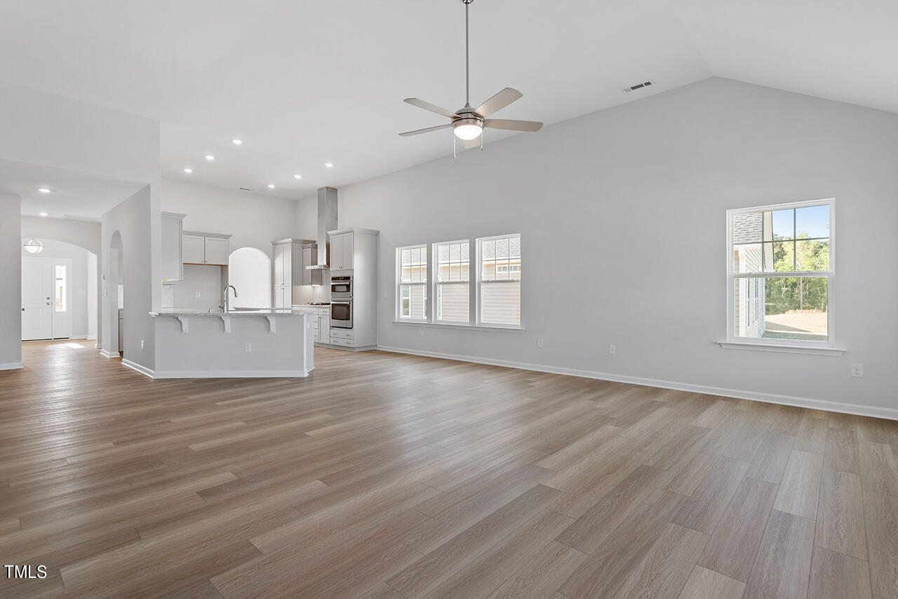 63 Beech Tree Way, Unit 139 Garner, NC 27529 - Photo 6 of 25 a view of empty room with wooden floor and windows